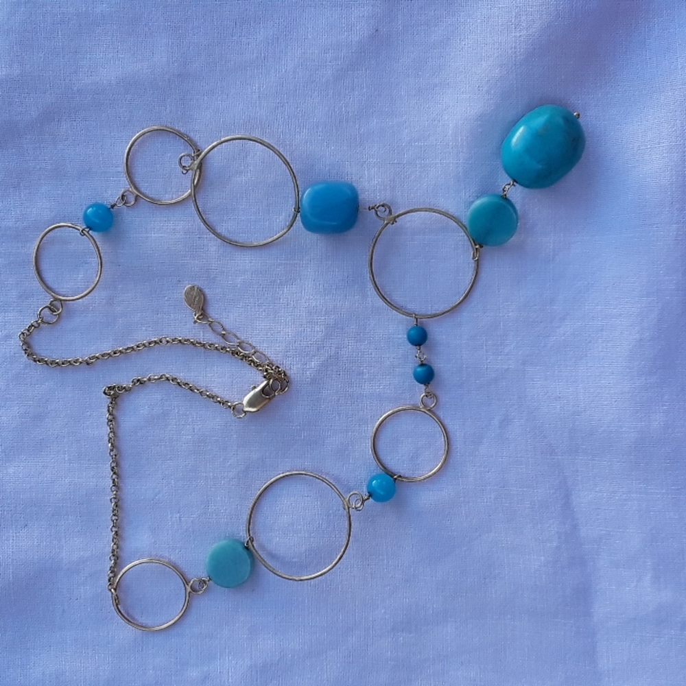 Gold necklace with turquoise and other stones.